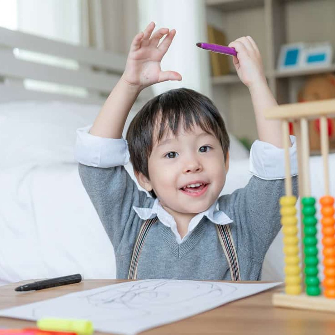 little-cute-boy-proud-when-he-finish-drawing-with-happiness-raised-two-hands-his-head-smile